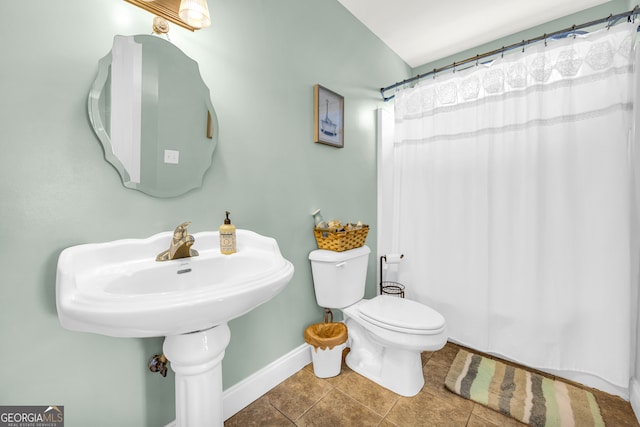 bathroom with tile patterned floors and toilet