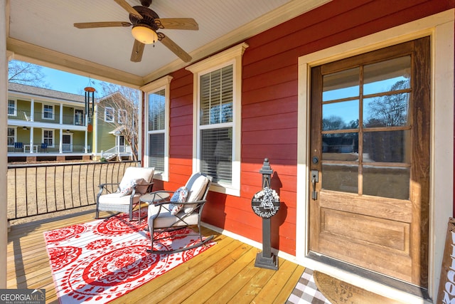 deck with ceiling fan and a porch