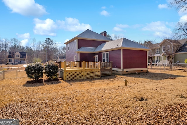 rear view of property featuring a deck