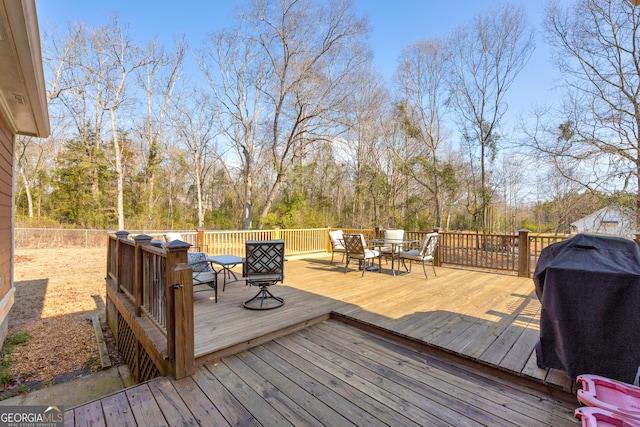 wooden deck featuring a grill