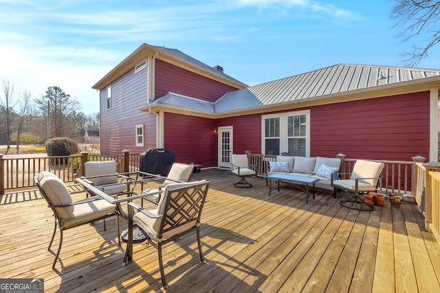 deck featuring an outdoor living space and a grill