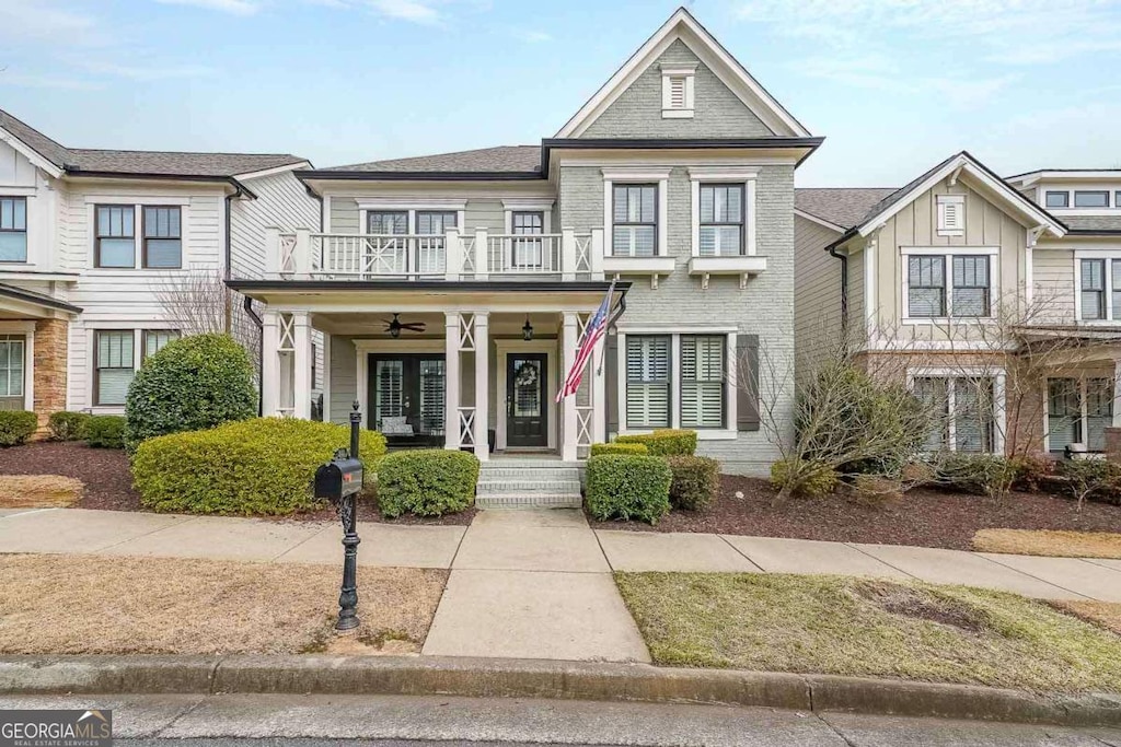 view of front of house featuring a balcony, ceiling fan, and a porch