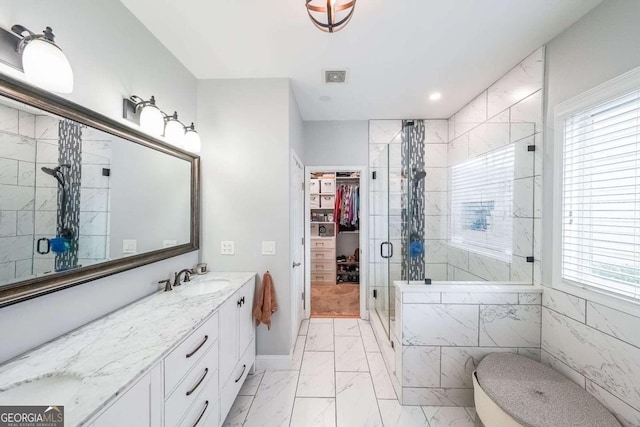 bathroom with a shower with door and vanity