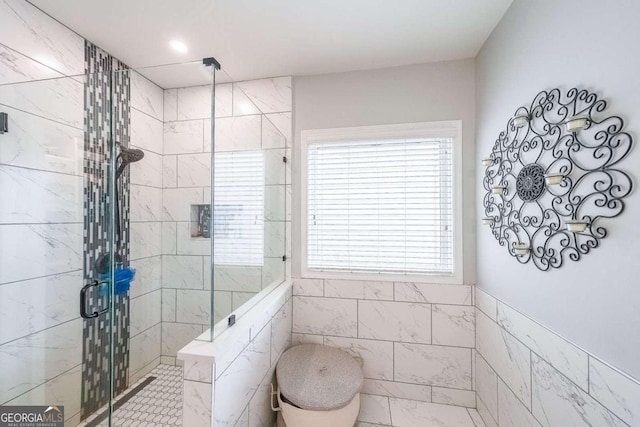 bathroom with tile walls and walk in shower