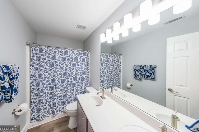 bathroom with vanity, wood-type flooring, a shower with shower curtain, and toilet