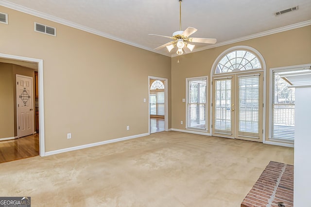 carpeted spare room featuring crown molding and ceiling fan