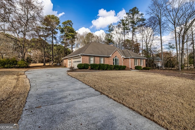 view of front of house with a garage and a front yard