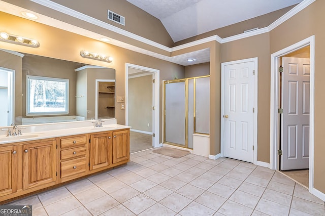 bathroom featuring lofted ceiling, ornamental molding, tile patterned floors, and walk in shower