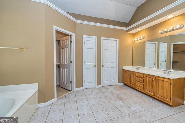 bathroom with vanity, ornamental molding, a tub to relax in, vaulted ceiling, and tile patterned floors