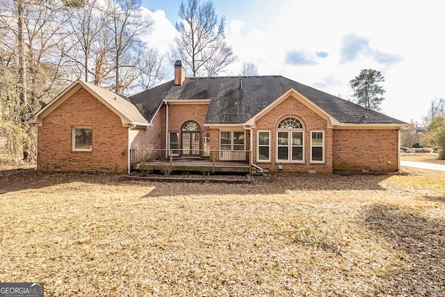 rear view of property featuring a wooden deck