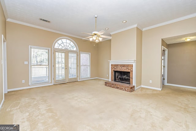 unfurnished living room with crown molding, a brick fireplace, and carpet floors