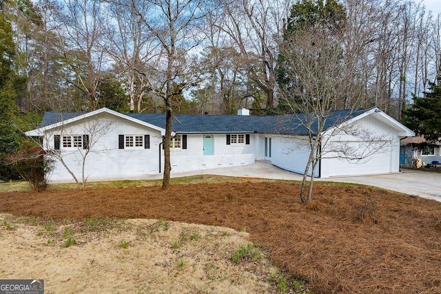 ranch-style home featuring a garage