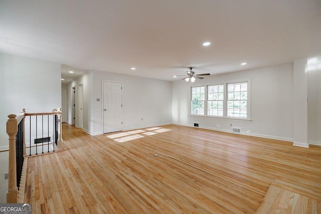 empty room with ceiling fan and light wood-type flooring