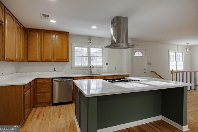 kitchen featuring sink, dishwasher, a center island, island range hood, and black gas stovetop