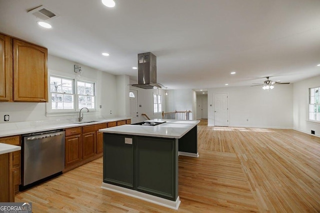 kitchen featuring sink, island range hood, light wood-type flooring, dishwasher, and a kitchen island