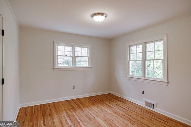 unfurnished room featuring crown molding, light hardwood / wood-style floors, and a healthy amount of sunlight