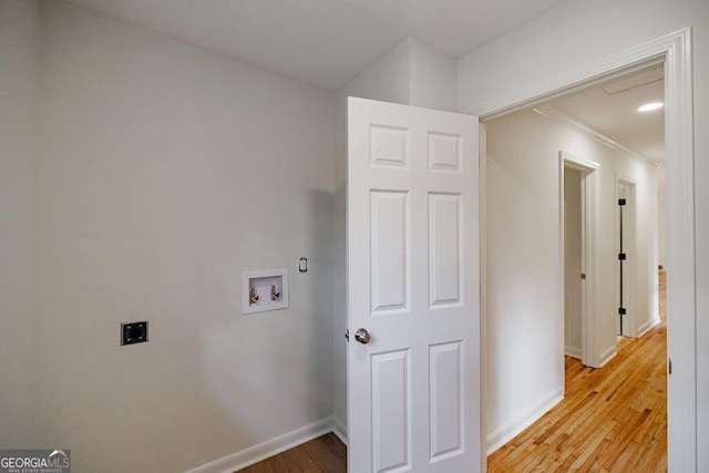 laundry room featuring hookup for an electric dryer, light hardwood / wood-style floors, and hookup for a washing machine