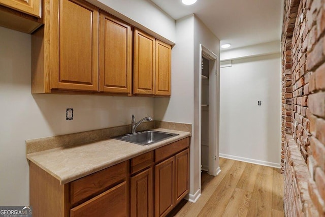 kitchen featuring sink and light wood-type flooring