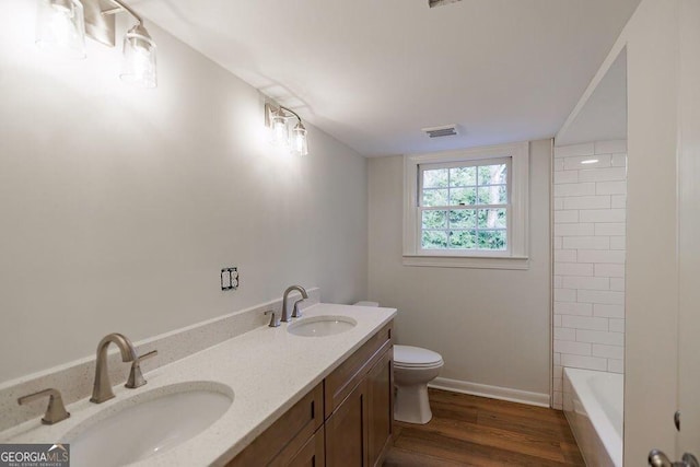 bathroom featuring hardwood / wood-style flooring, vanity, and toilet