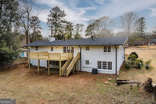 rear view of house featuring central AC unit and a deck