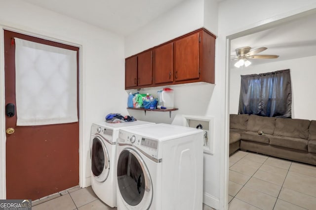 laundry area featuring light tile patterned floors, washing machine and dryer, cabinets, and ceiling fan