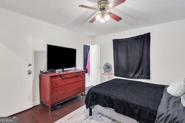 bedroom with dark hardwood / wood-style floors and ceiling fan