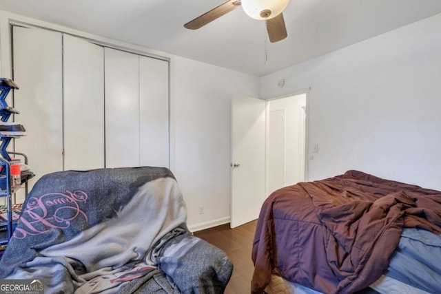 bedroom featuring dark hardwood / wood-style flooring, a closet, and ceiling fan