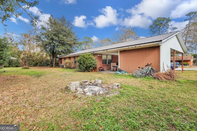 rear view of property featuring a yard