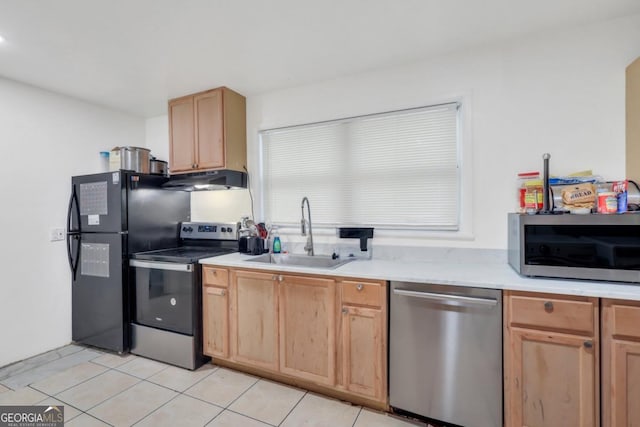 kitchen with light brown cabinetry, sink, light tile patterned floors, and stainless steel appliances