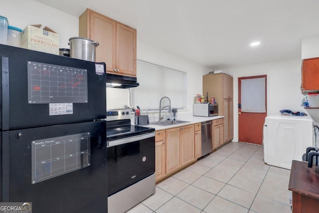 kitchen with light brown cabinetry, sink, light tile patterned floors, stainless steel appliances, and washer / clothes dryer