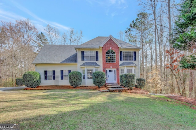 colonial-style house with a front lawn