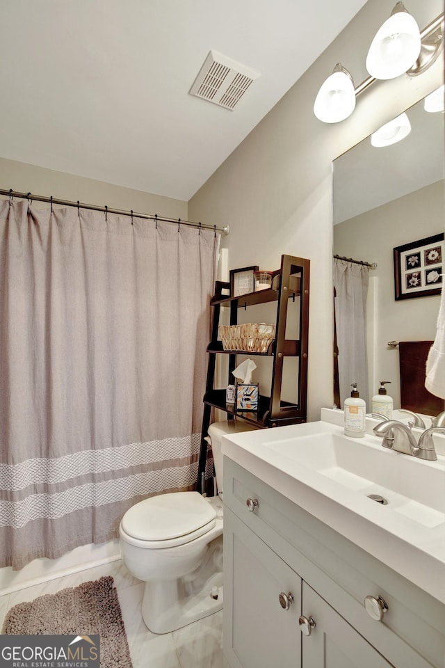 full bathroom with vanity, shower / bath combo, and toilet