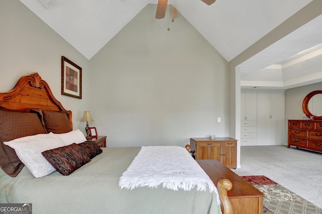 bedroom with ceiling fan, carpet flooring, vaulted ceiling, and a closet