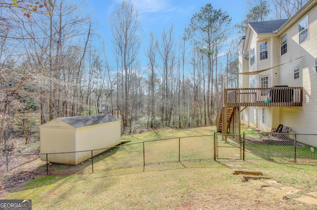 view of yard with a wooden deck and a shed