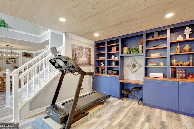 workout area featuring built in desk, a notable chandelier, wood ceiling, light hardwood / wood-style floors, and crown molding