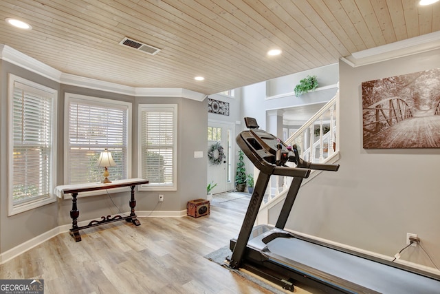 workout area with ornamental molding, light hardwood / wood-style flooring, and wooden ceiling