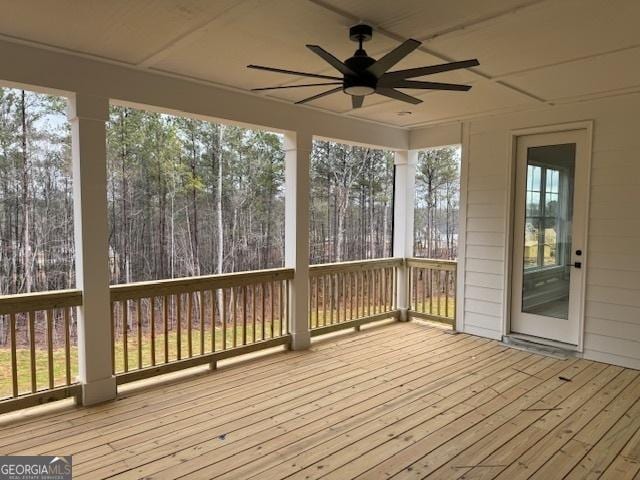 unfurnished sunroom featuring ceiling fan