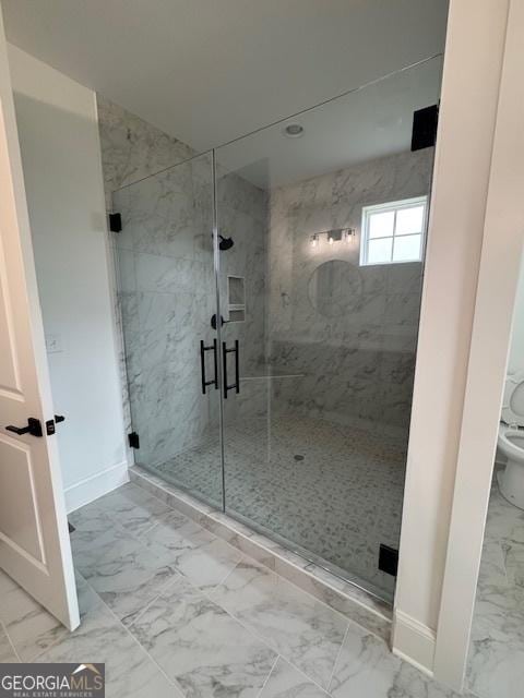 bathroom with marble finish floor, toilet, a marble finish shower, and baseboards
