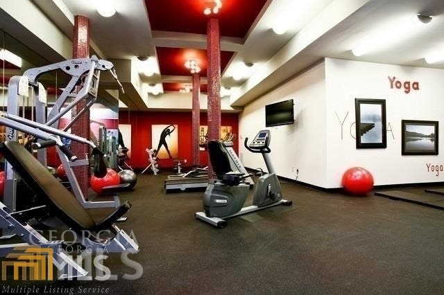 gym featuring a tray ceiling