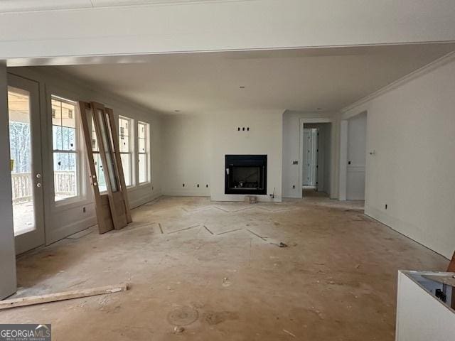 unfurnished living room with crown molding and french doors