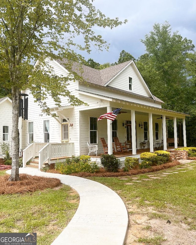 view of front of property with covered porch and a front yard