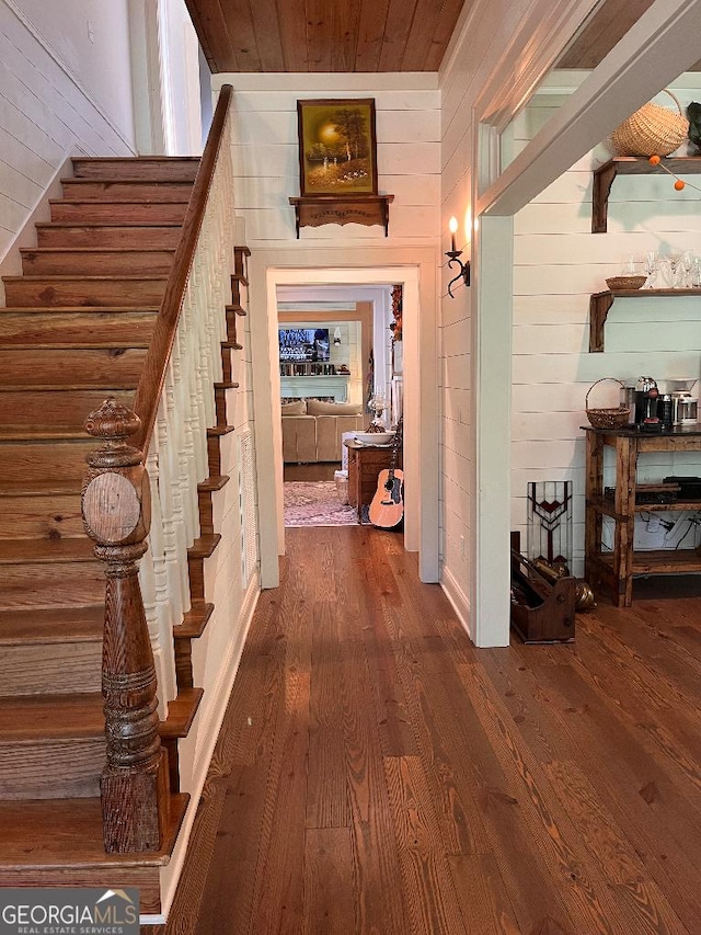 182 Rogers St, Hazlehurst, GA 31539 - hall with wooden walls, wood finished floors, stairs, and wooden ceiling