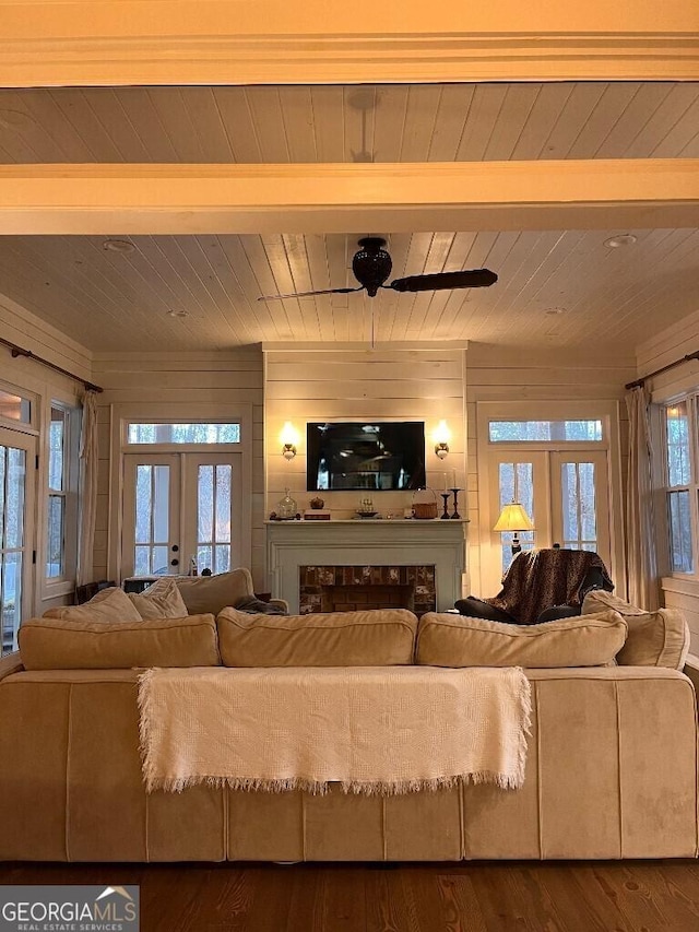 living room featuring wood walls, hardwood / wood-style floors, wooden ceiling, and french doors