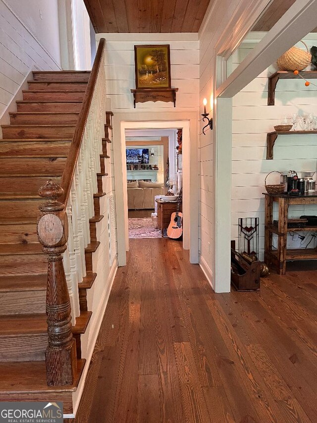 182 Rogers St, Hazlehurst, GA 31539 - corridor with wood walls, wood finished floors, stairway, and wooden ceiling