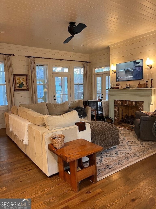 living room featuring wood-type flooring, ceiling fan, wood ceiling, and french doors