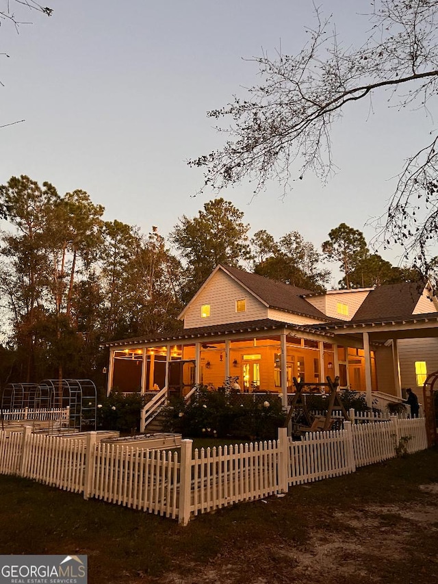 view of back house at dusk