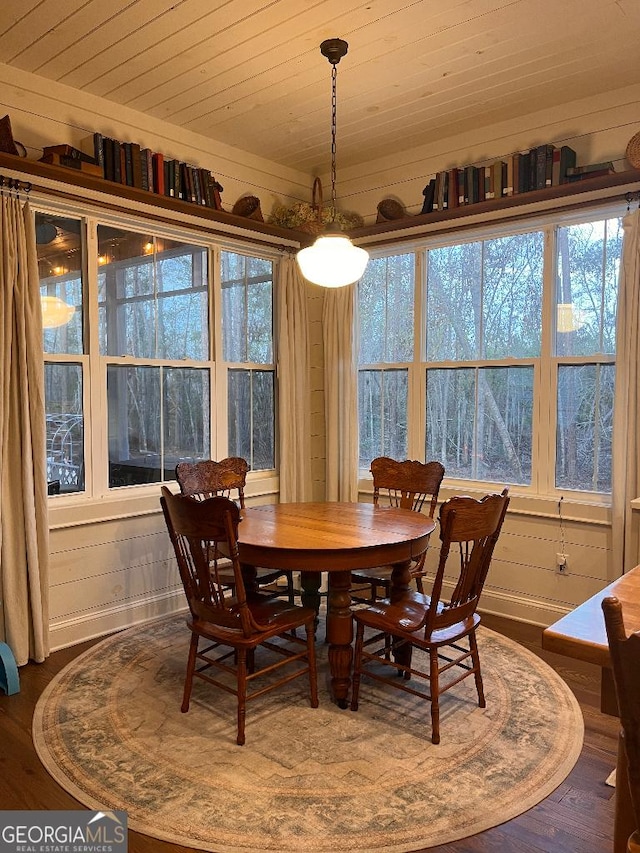 dining space featuring wood ceiling, wood-type flooring, and a healthy amount of sunlight