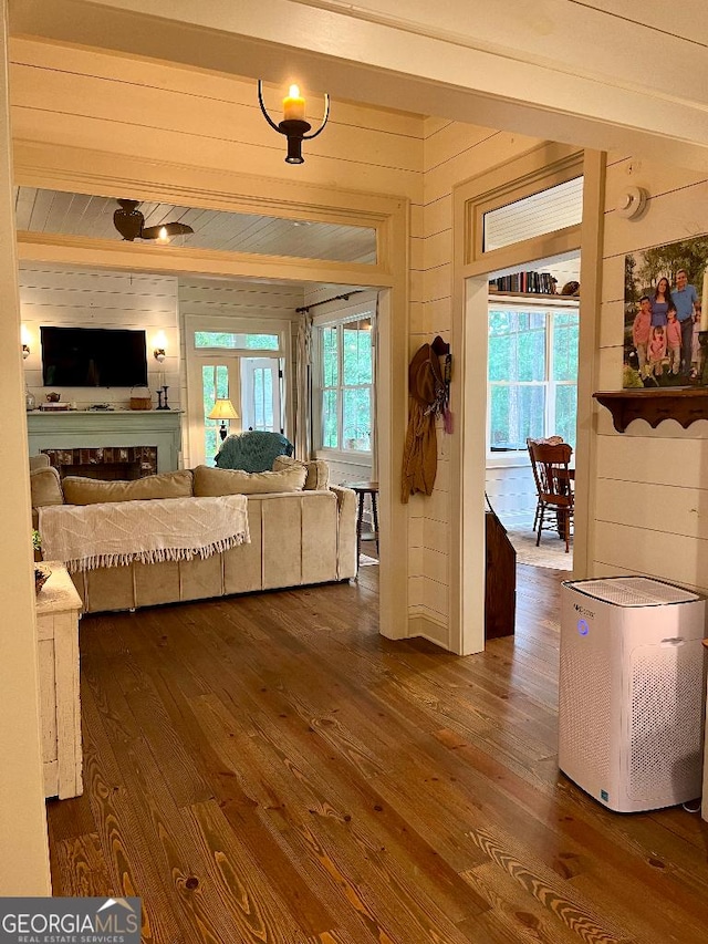 182 Rogers St, Hazlehurst, GA 31539 - living room featuring dark wood-style flooring, wooden walls, and plenty of natural light
