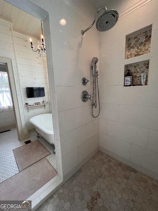 bathroom with separate shower and tub and a notable chandelier