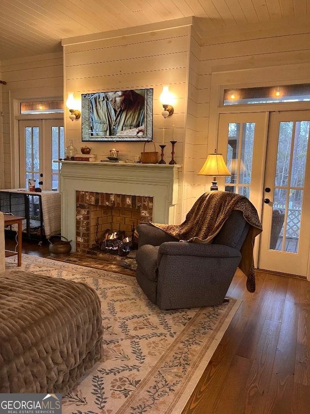 182 Rogers St, Hazlehurst, GA 31539 - living room with french doors, wooden ceiling, wooden walls, hardwood / wood-style floors, and plenty of natural light